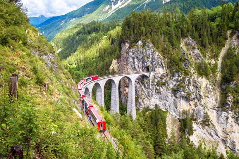 The Bernina Express red train passing through the Alps 