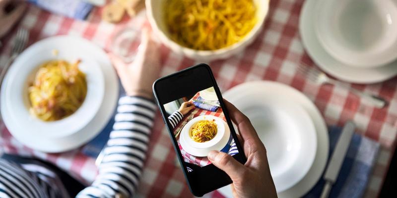 Taking photo of food on table