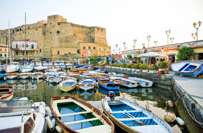 Castel dell'Ovo and harbor with boats in Naples