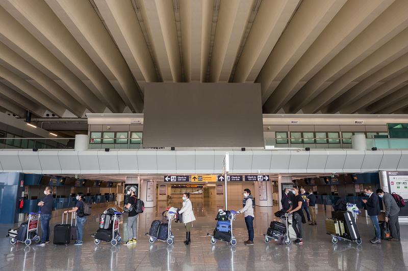 Passengers in line wearing masks at Fiumicino Airport in Rome