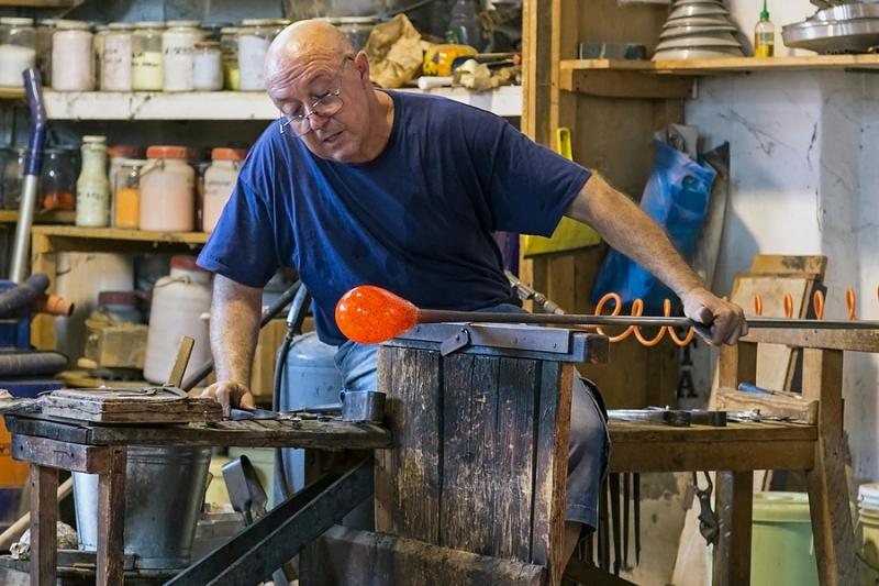 Glass bead artisan working in Murano Venice